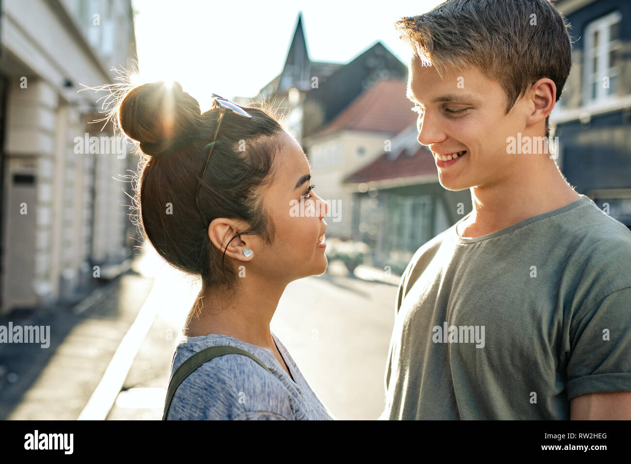 Young couple looking into each other's eyes in the city Stock Photo Alamy