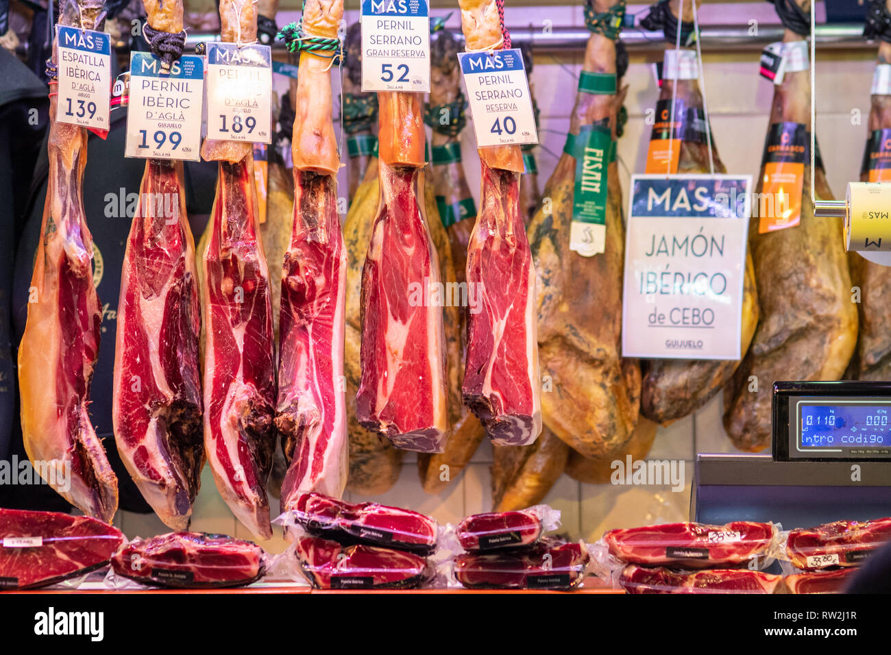 Jam—n IbŽrico de Bellota hams  hanging for sale at La Boqueria Food Market in Barcelona ,Spain La Boqueria Food Market in Barcelona ,Spain Stock Photo