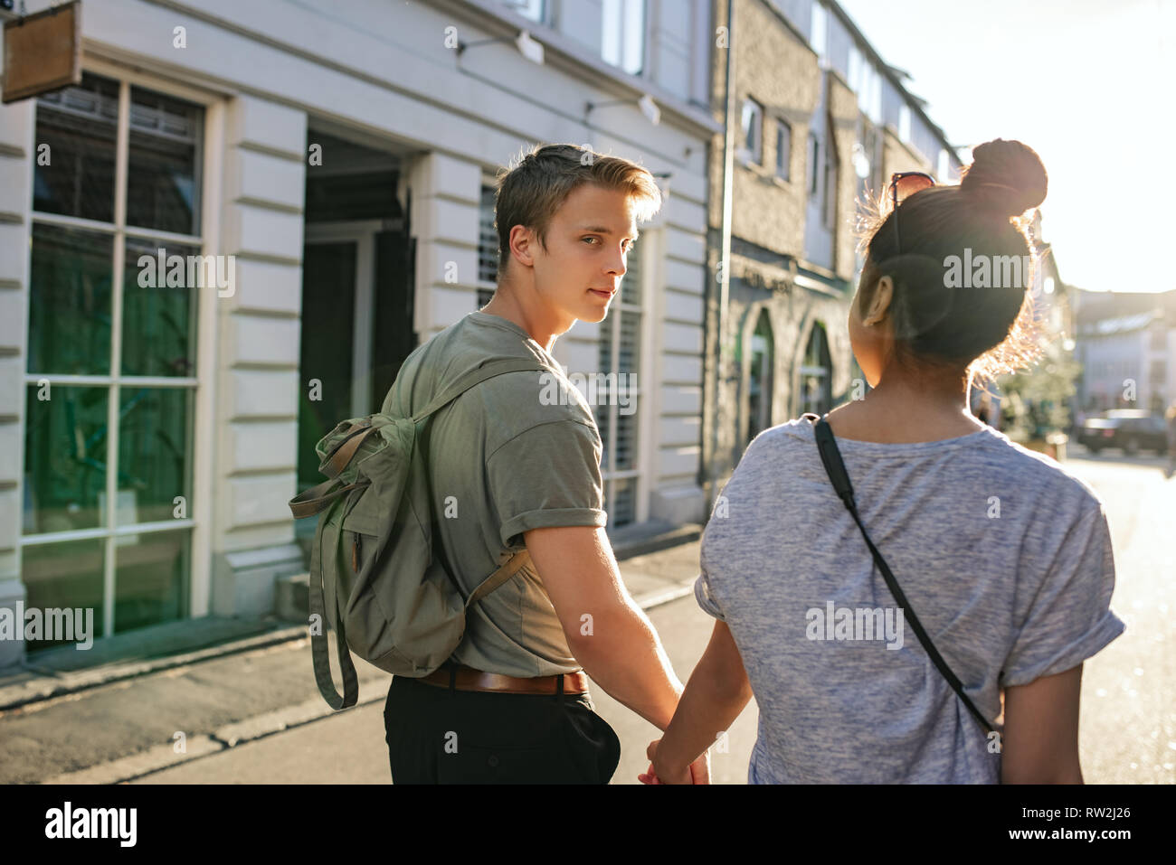 Young man and his girlfriend exploring the city together Stock Photo