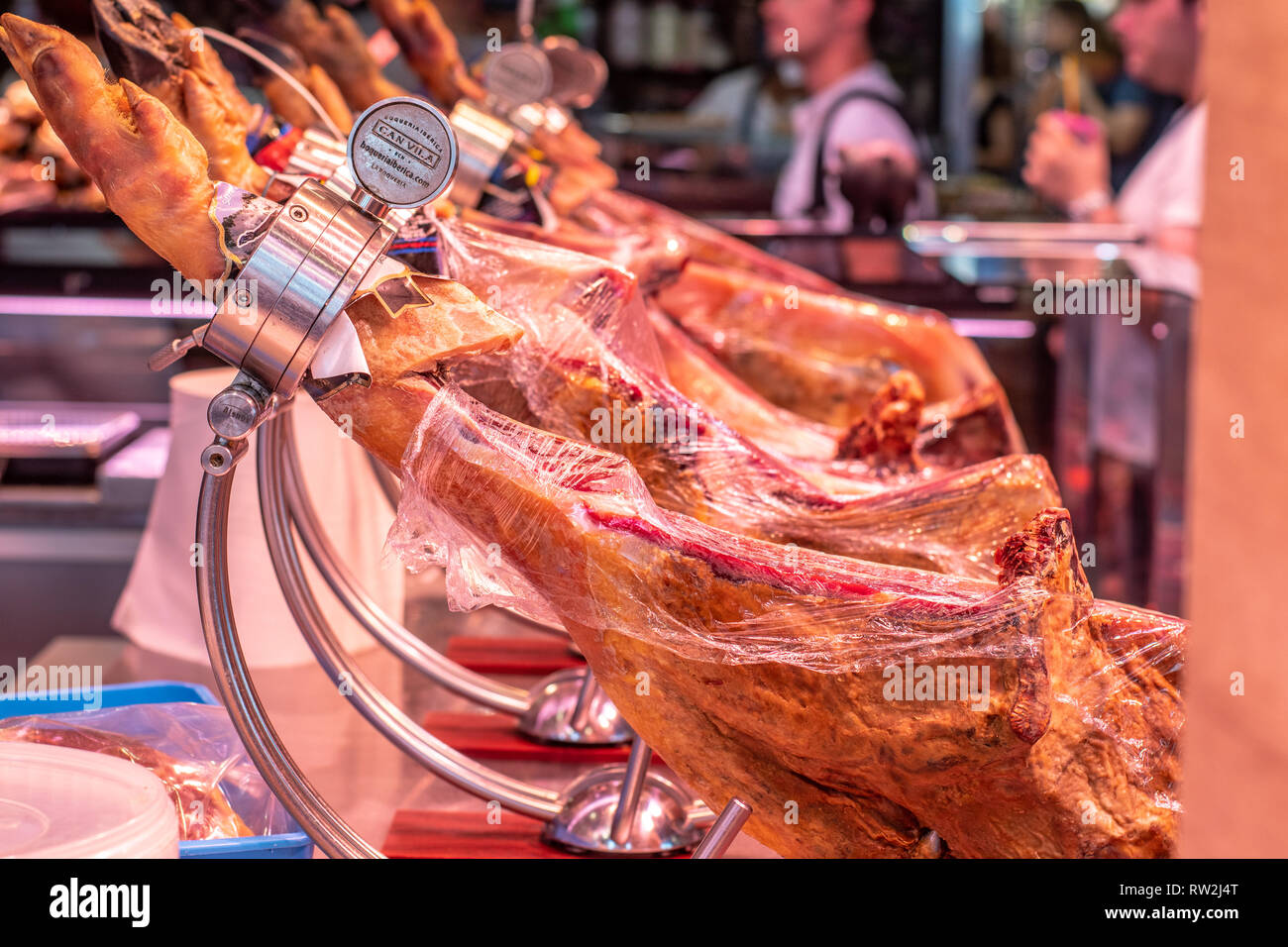 Jam—n IbŽrico de Bellota hams  ready for slicing at La Boqueria Food Market in Barcelona ,Spain Stock Photo