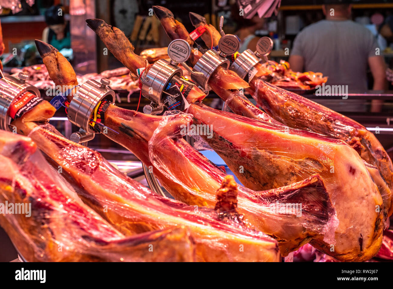 Jam—n IbŽrico de Bellota hams  ready for slicing at La Boqueria Food Market in Barcelona ,Spain Stock Photo