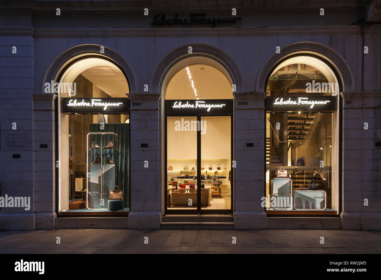 Salvatore Ferragamo retail outlet in Calle Larga XXII Marzo, San Marco,  Venice, Veneto, Italy illuminated at night with signage. Shop assistant  inside Stock Photo - Alamy