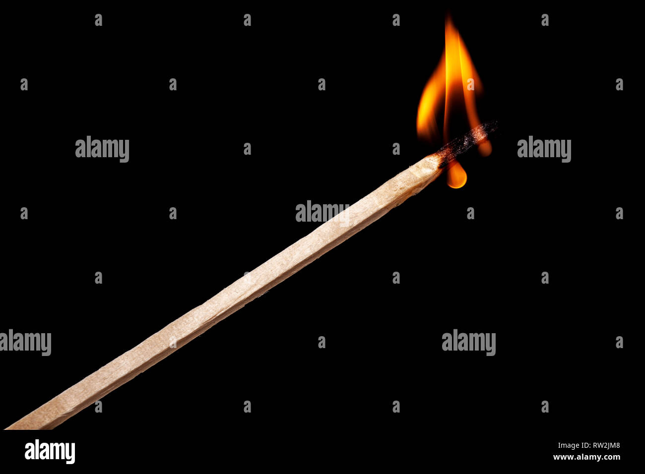 one long match stick burning against black background Stock Photo - Alamy