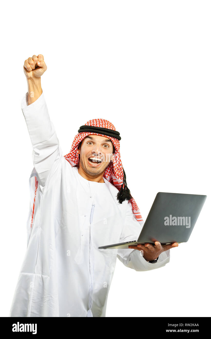Arab sheik holding a laptop cheering success Stock Photo