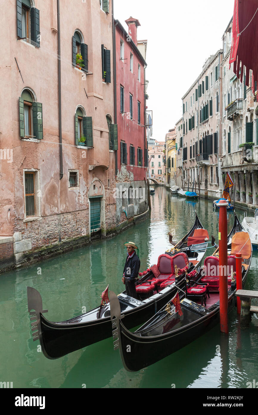 Gondolas and gondolier on a back canal in Cannaregio, Venice Veneto, Italy in autumn Stock Photo