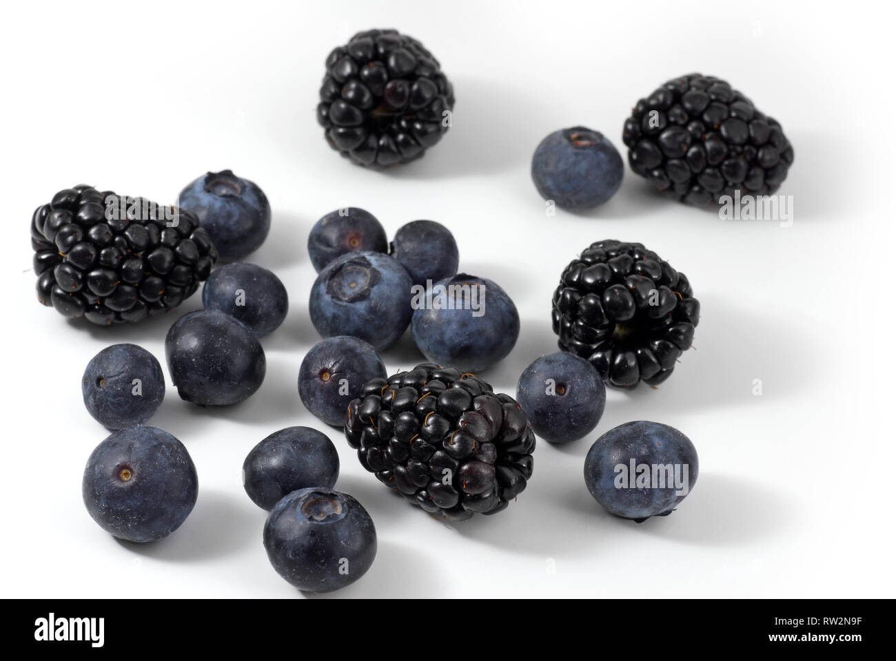 Blueberries and blackberries on white background Stock Photo