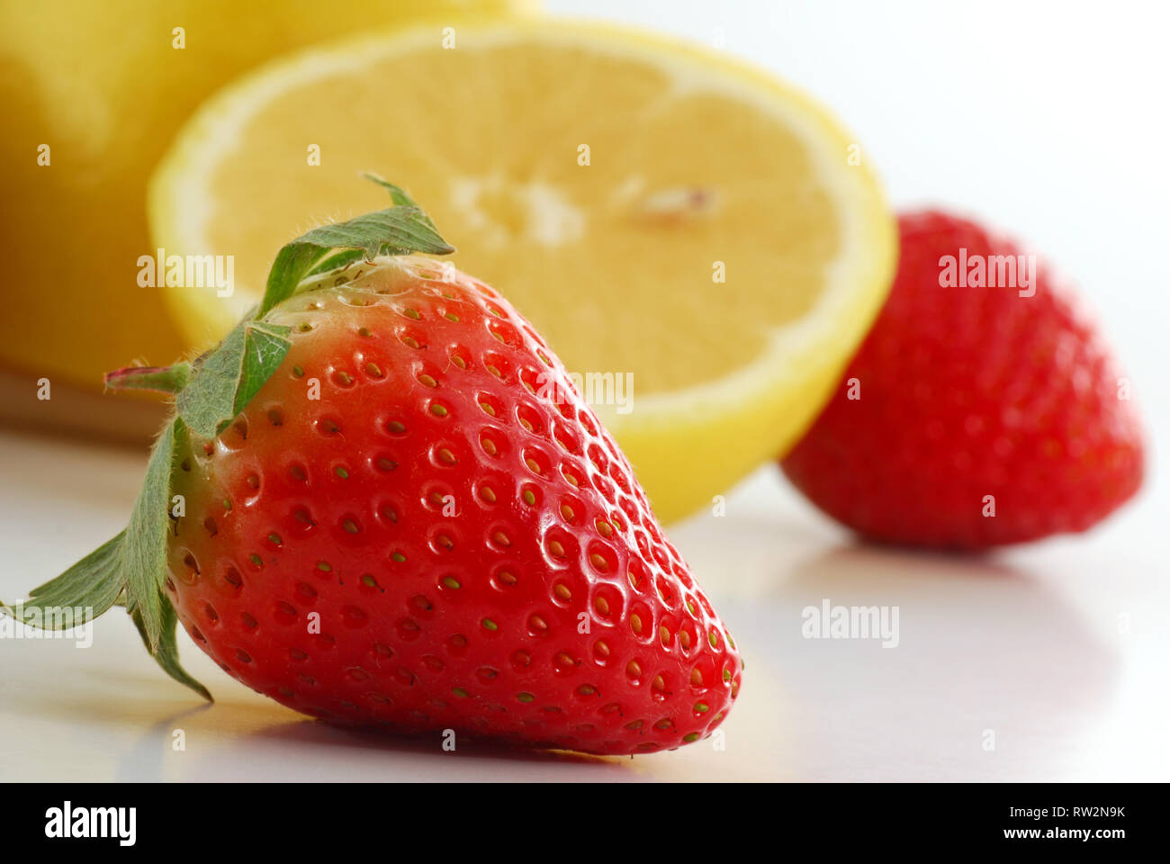 Extreme close-up image of a strawberry with more fruit in background Stock Photo