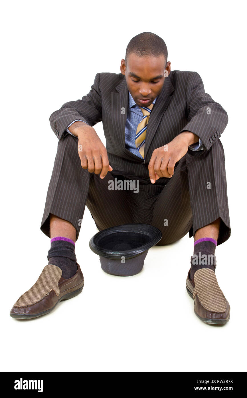 young depressed black businessman sitting in a corner Stock Photo