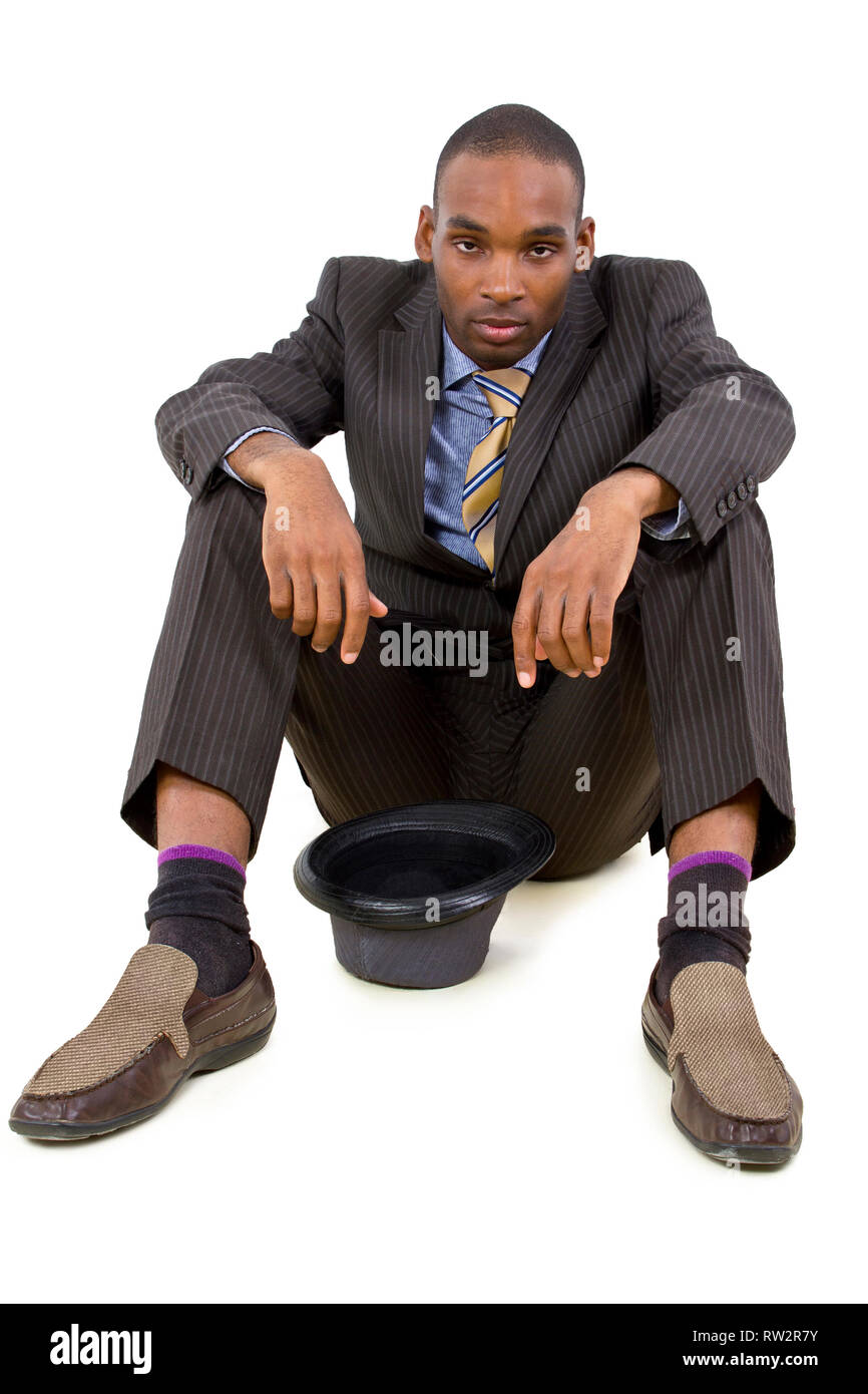 young depressed black businessman sitting in a corner Stock Photo