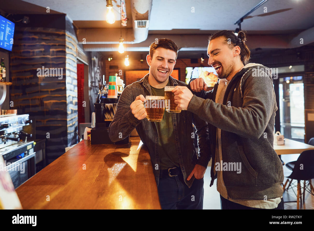 Friends talk, drink beer in a bar. Stock Photo