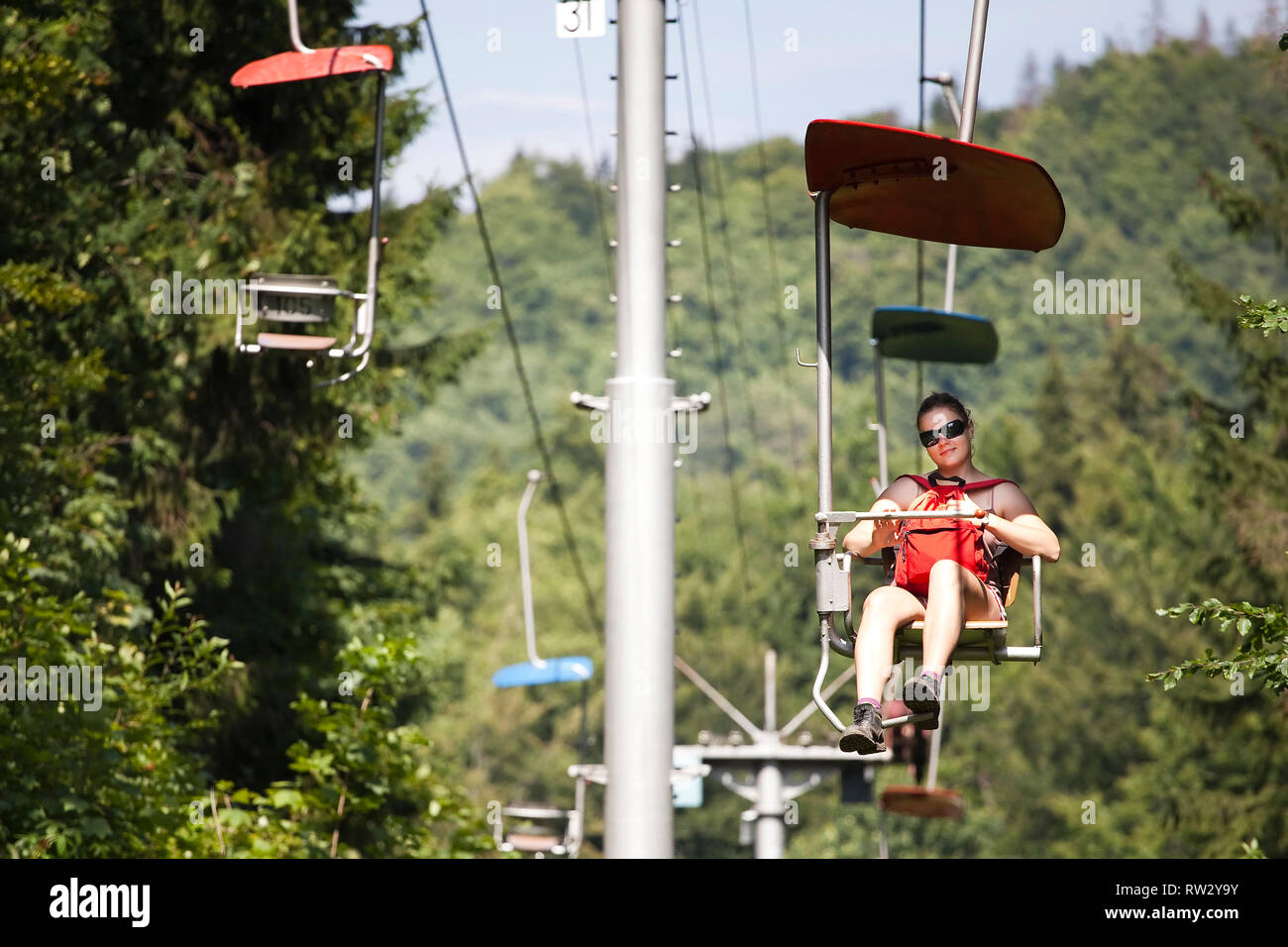 woman on chairlift in Dedinky, Slovak Paradise Stock Photo
