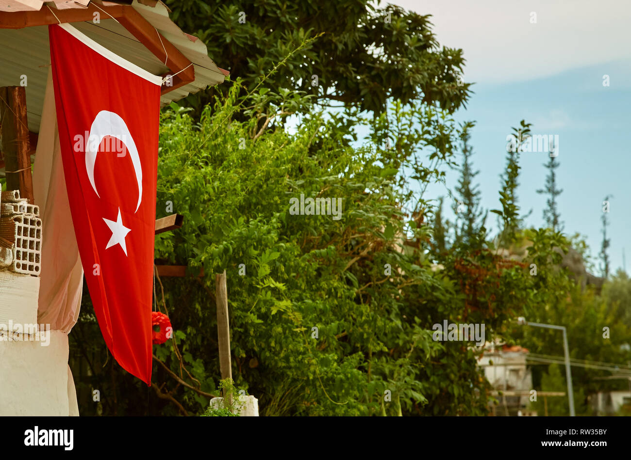 Turkish flag on a street in a city on a trees background Stock Photo ...