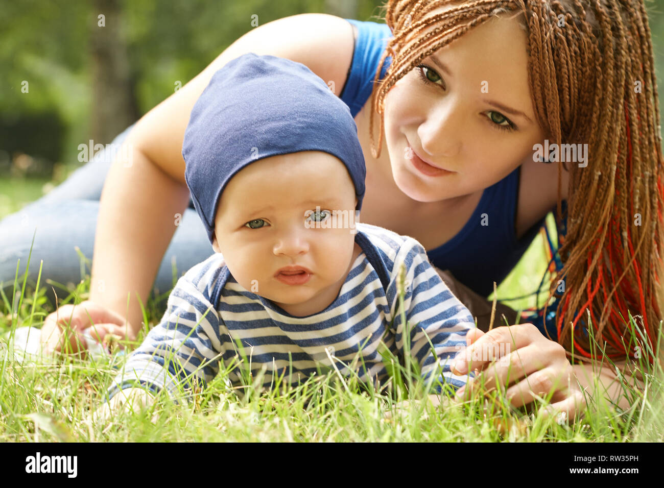 Young Mother Playing With Her Baby Mom And Son In A Park Stock