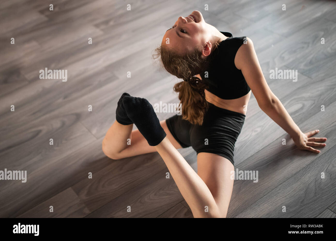 Beautiful girl practicing and exercising modern ballet at dance school Stock Photo