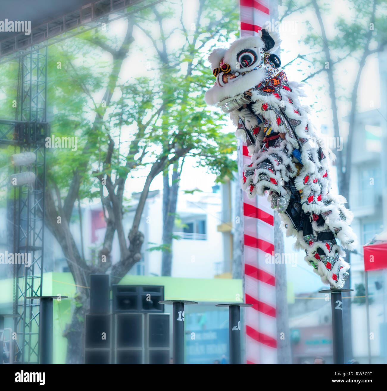 Practitioners in costume lion dancing perform on stage in Van Lang Park, District 5, to pray, safety and luck in new year attract visitors to see Stock Photo