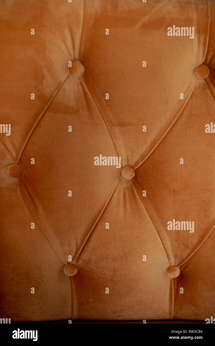 Upholstery orange sofa or chair .Velvet with buttons. Texture Stock Photo Alamy