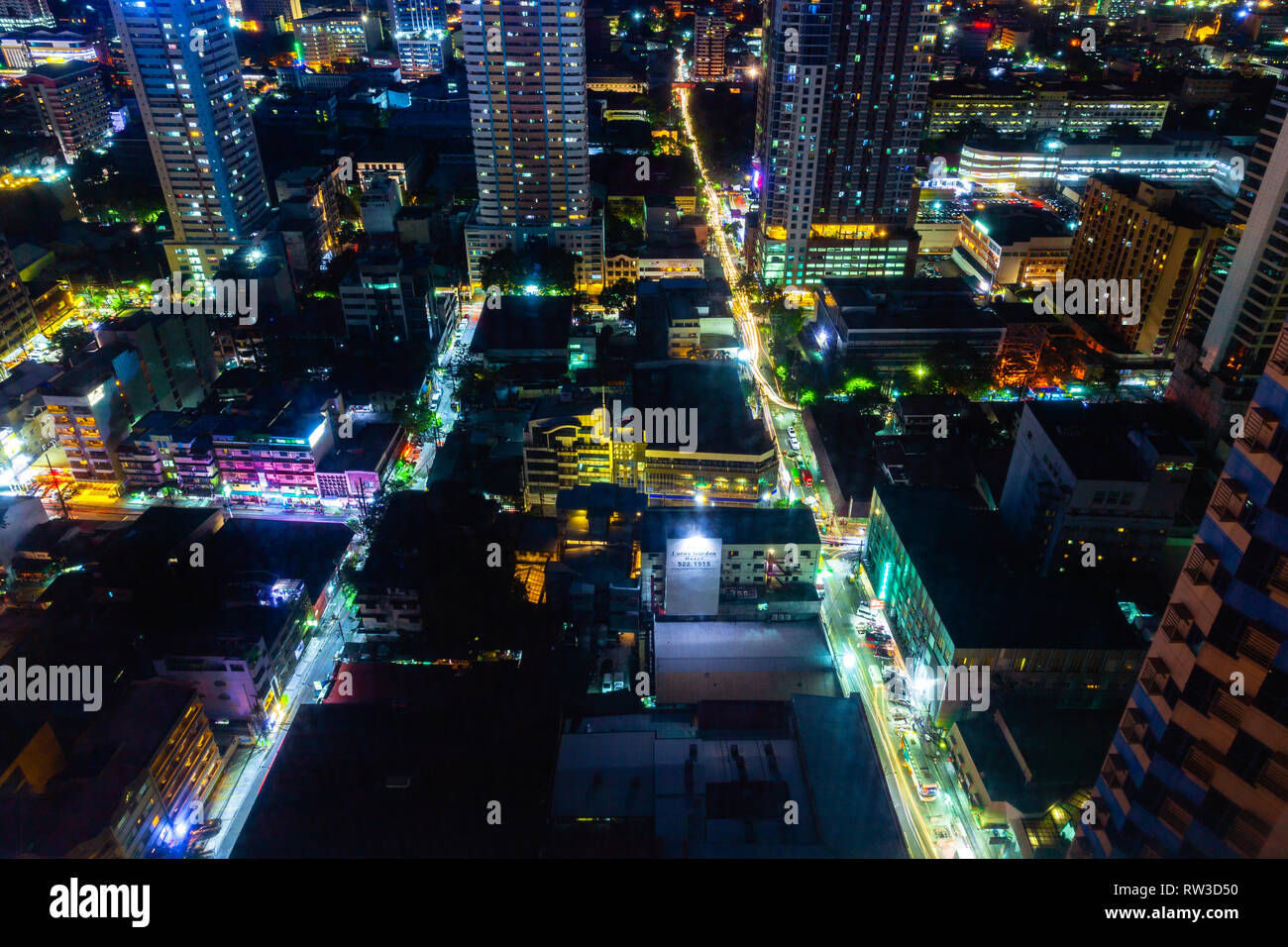 Manila, Philippines - November 11, 2018: Night view of the illuminated streets of the Malate district from above on November 11, 2018 in Metro Manila, Stock Photo