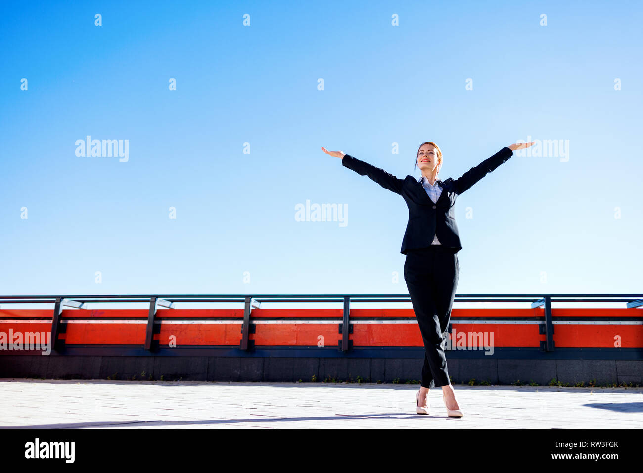 Business woman feels triumph on observation deck over Moscow city background. Stock Photo