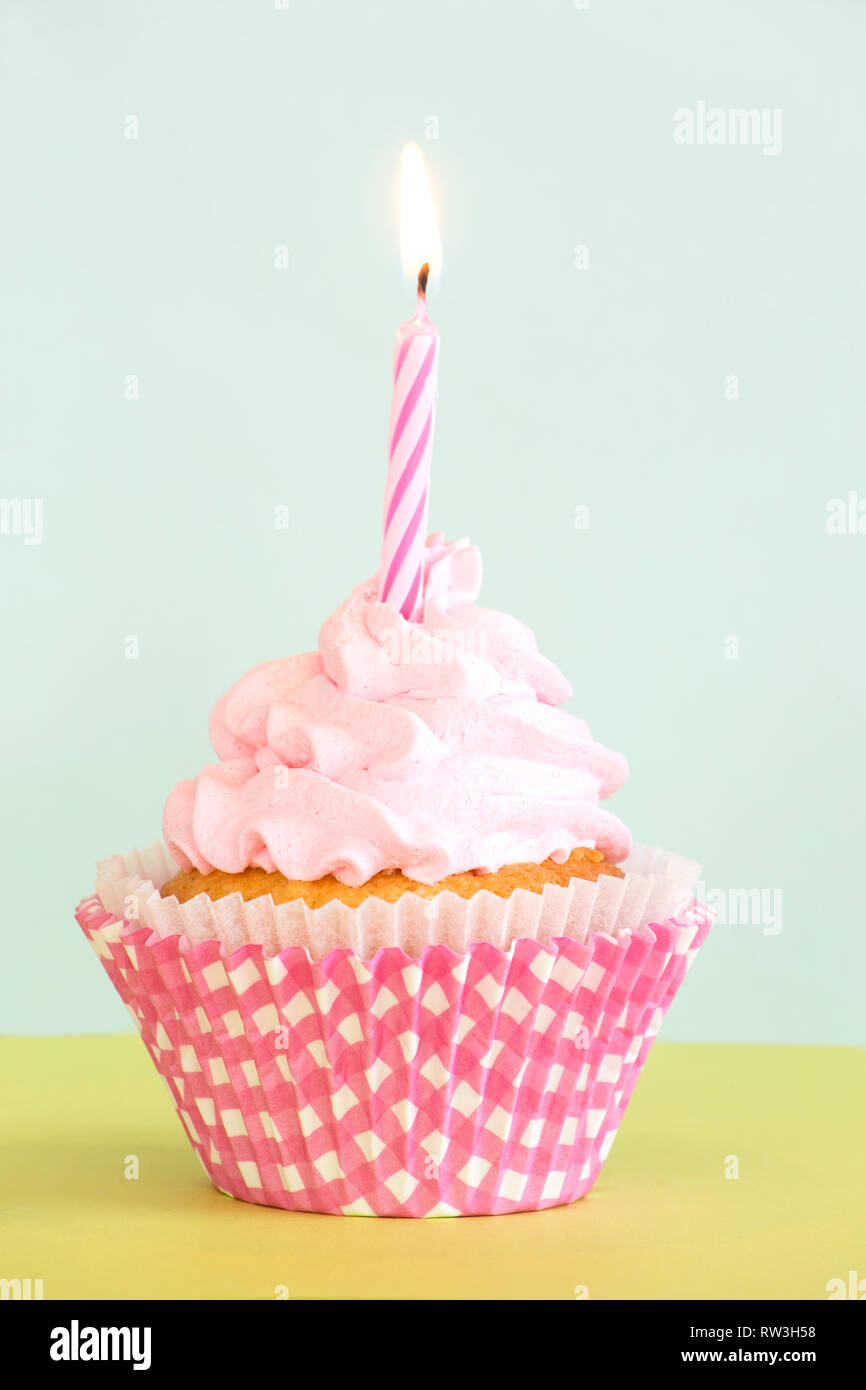 Birthday cupcake with the burning candle Stock Photo