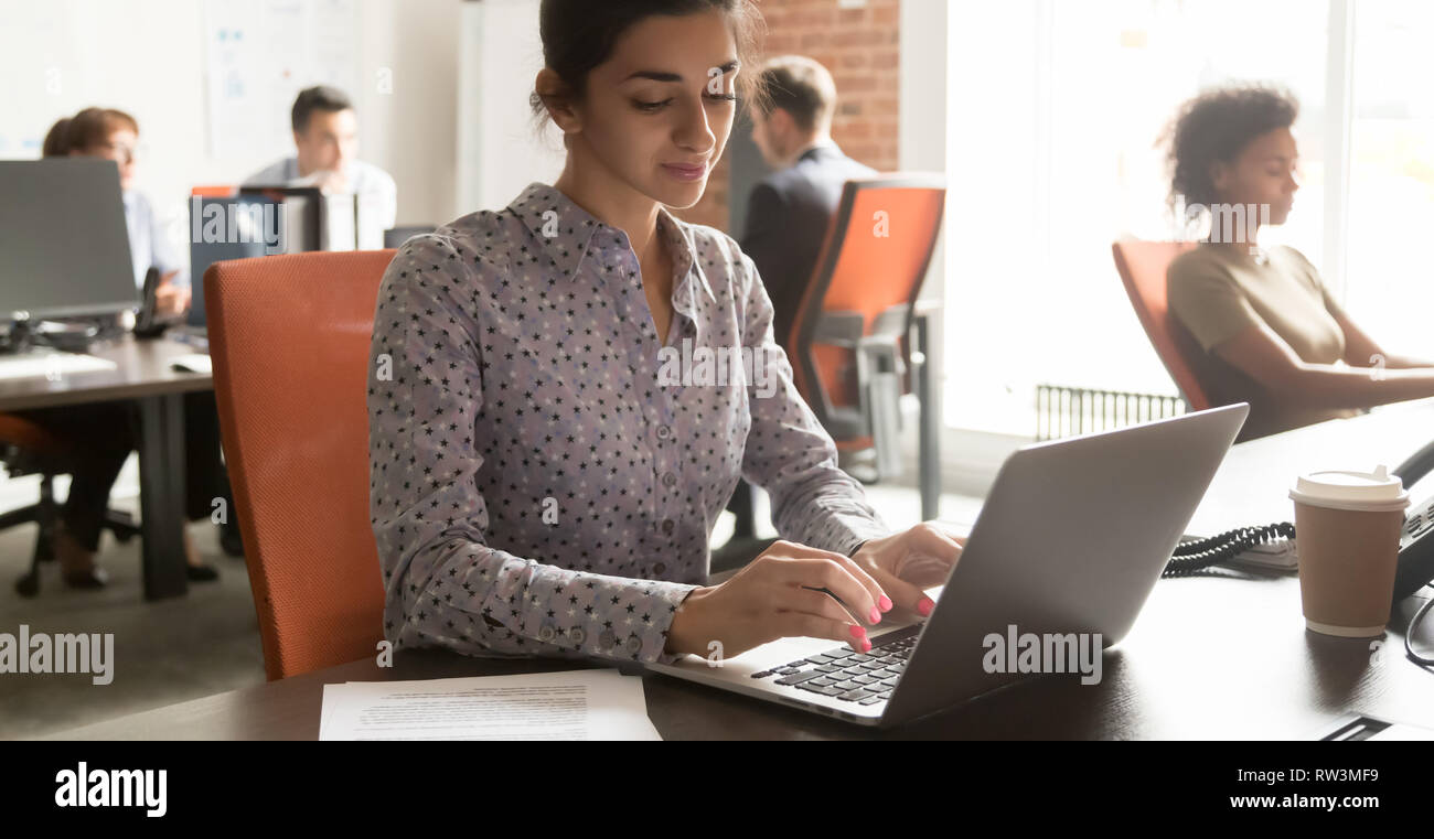 Young indian businesswoman employee using laptop at workplace in office Stock Photo