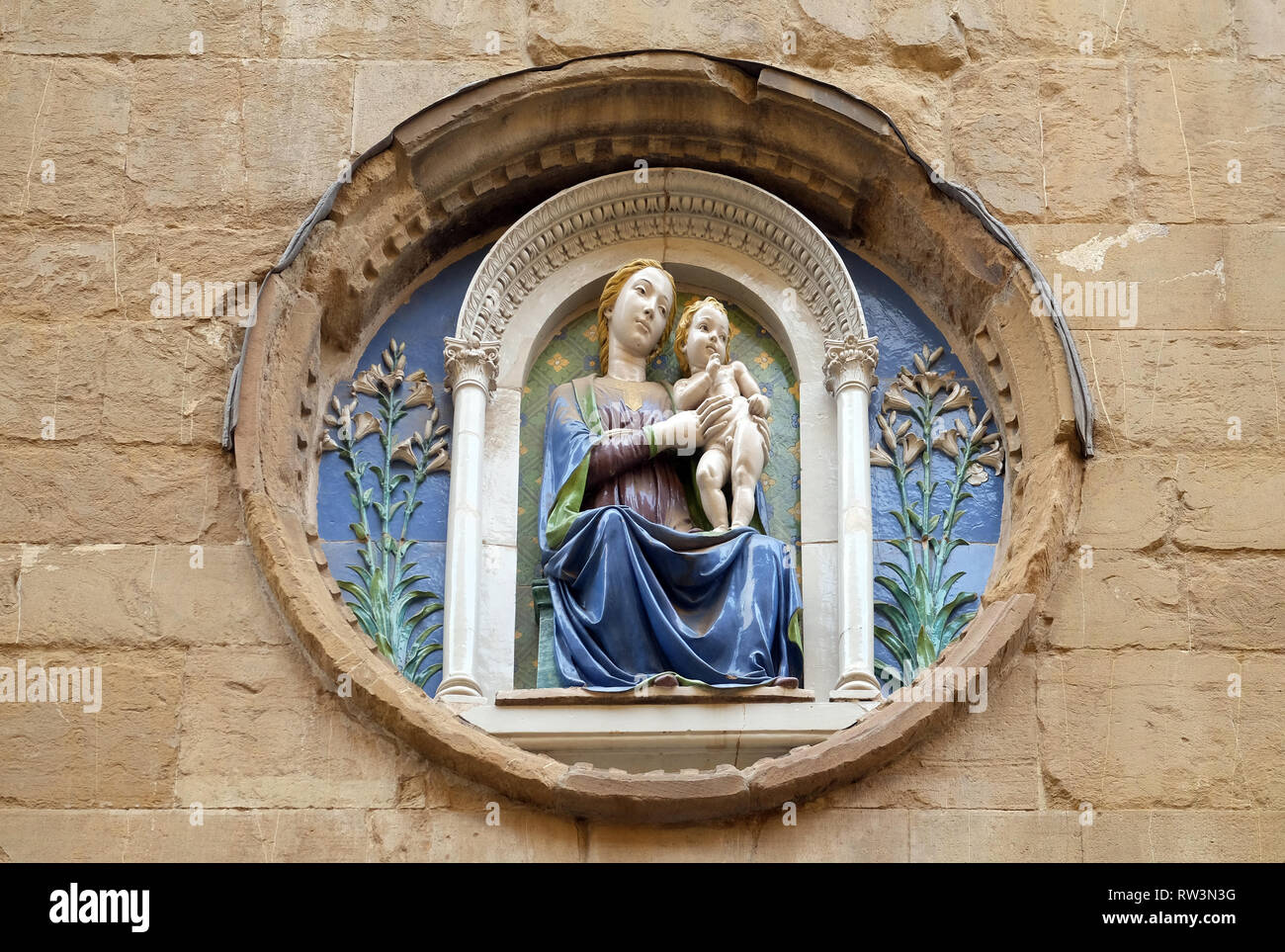 Medallion with the Virgin Mary and Child by Luca della Robbia on the facade of Orsanmichele Church in Florence, Tuscany, Italy Stock Photo