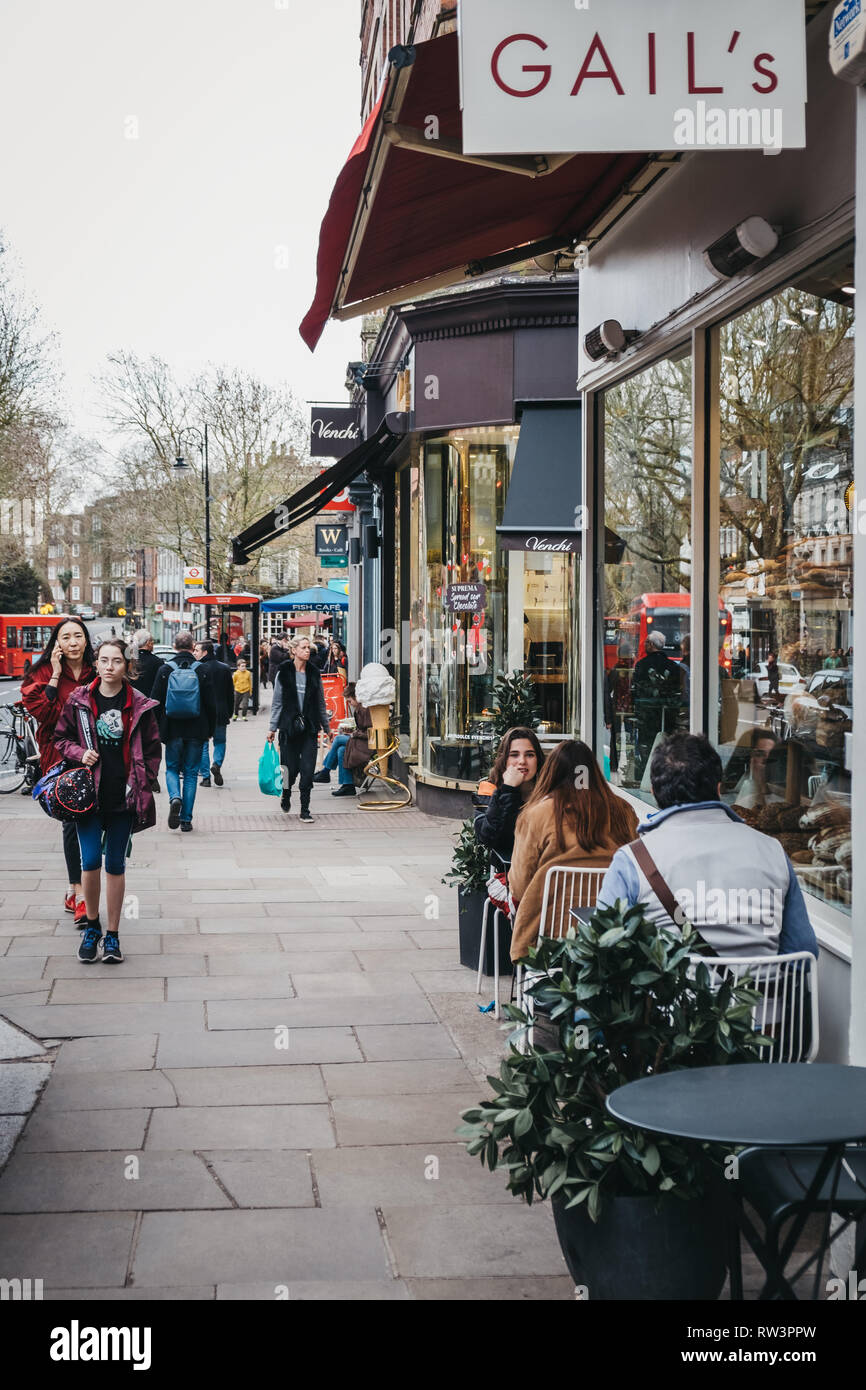 London, UK - March 2, 2019: People sitting at outdoor tables of Gails cafe in Hampstead, an affluent residential area of London favoured by academics, Stock Photo