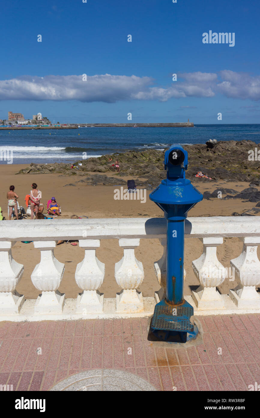 Seaside telescope overlooking beach at Castro Urdiales and looking towards the Church of Santa María de la Asunción Stock Photo