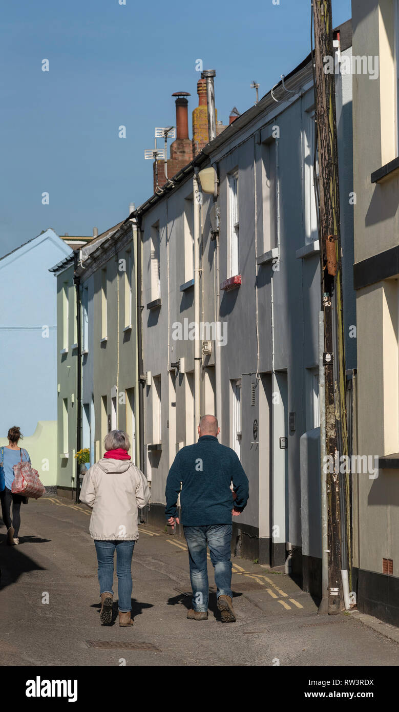 Appledore, North Devon, England, UK. February 2019. Couple in walking boots walking on very