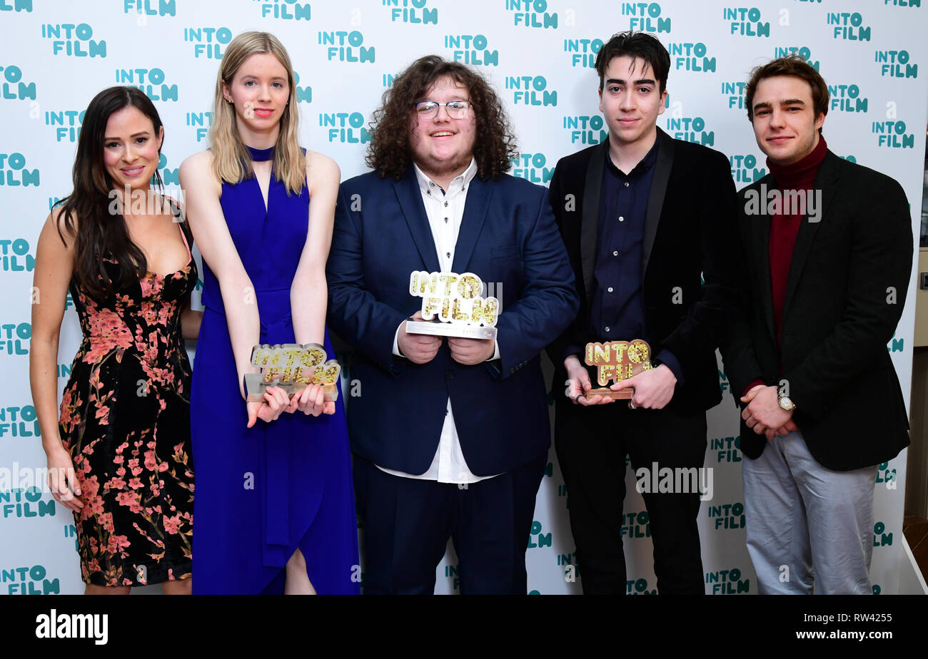 Camilla Thurlow and Nico Mirallegro present Oisin Thomas, Ruda Santos and Emilija Morrison with the Ones To Watch award during the fifth annual Into Film Awards, held at the Odeon Luxe in Leicester Square, London. Stock Photo