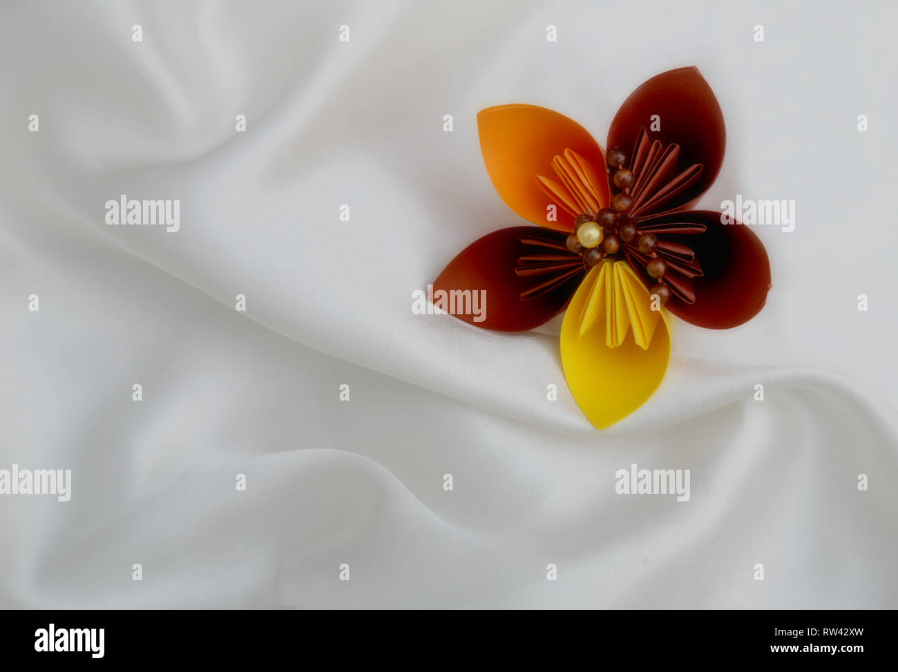 A Beautiful Origami Flower On A White Luxury Background