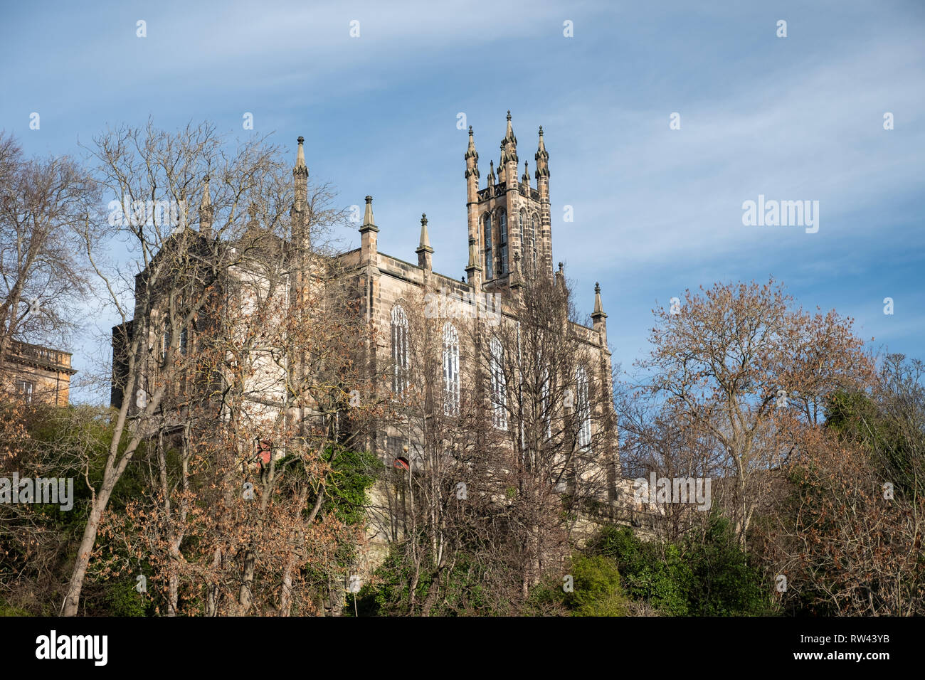 The Rhema Christian Centre Church viewed between the trees from Dean Village on a sunny day in Edinburgh, Scotland Stock Photo