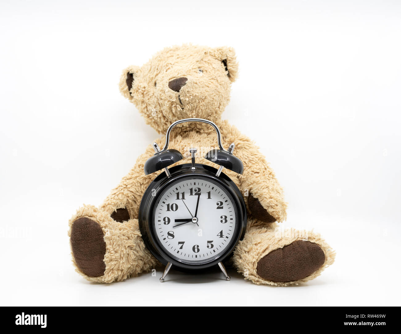 Time to go to bed concept with clock and teddy bear Stock Photo
