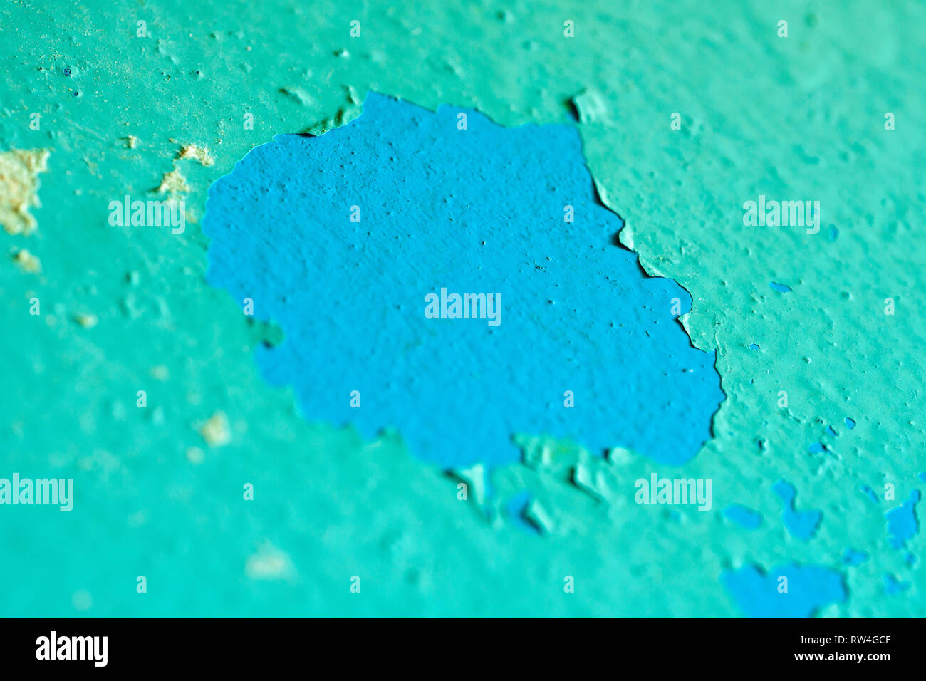 Peeling Blue Aquamarine Color Paint from the Wall. Shattered Plaster Background Stock Photo