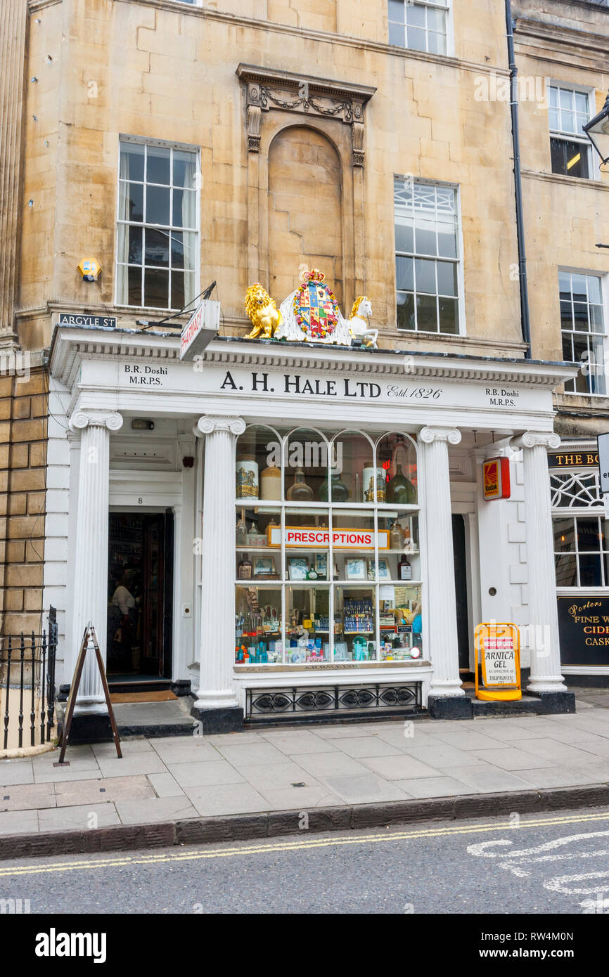 An impressive coat of arms above a traditional  chemist shop in Argyle Street, in Bath, N.E. Somerset, England, UK Stock Photo