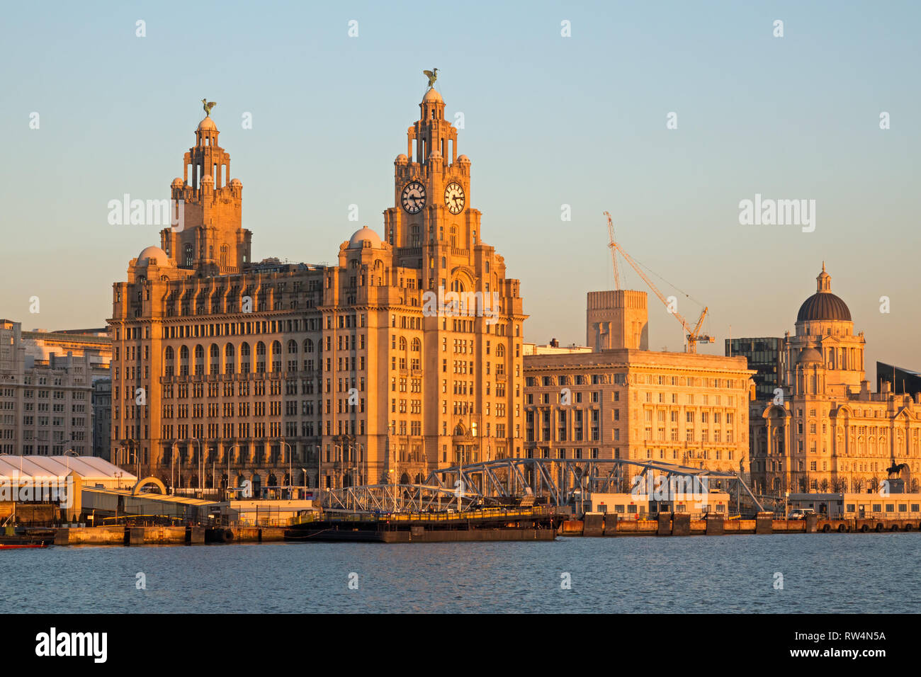 Liverpool's world famous waterfront buildings lit up by the late evening sun. Stock Photo