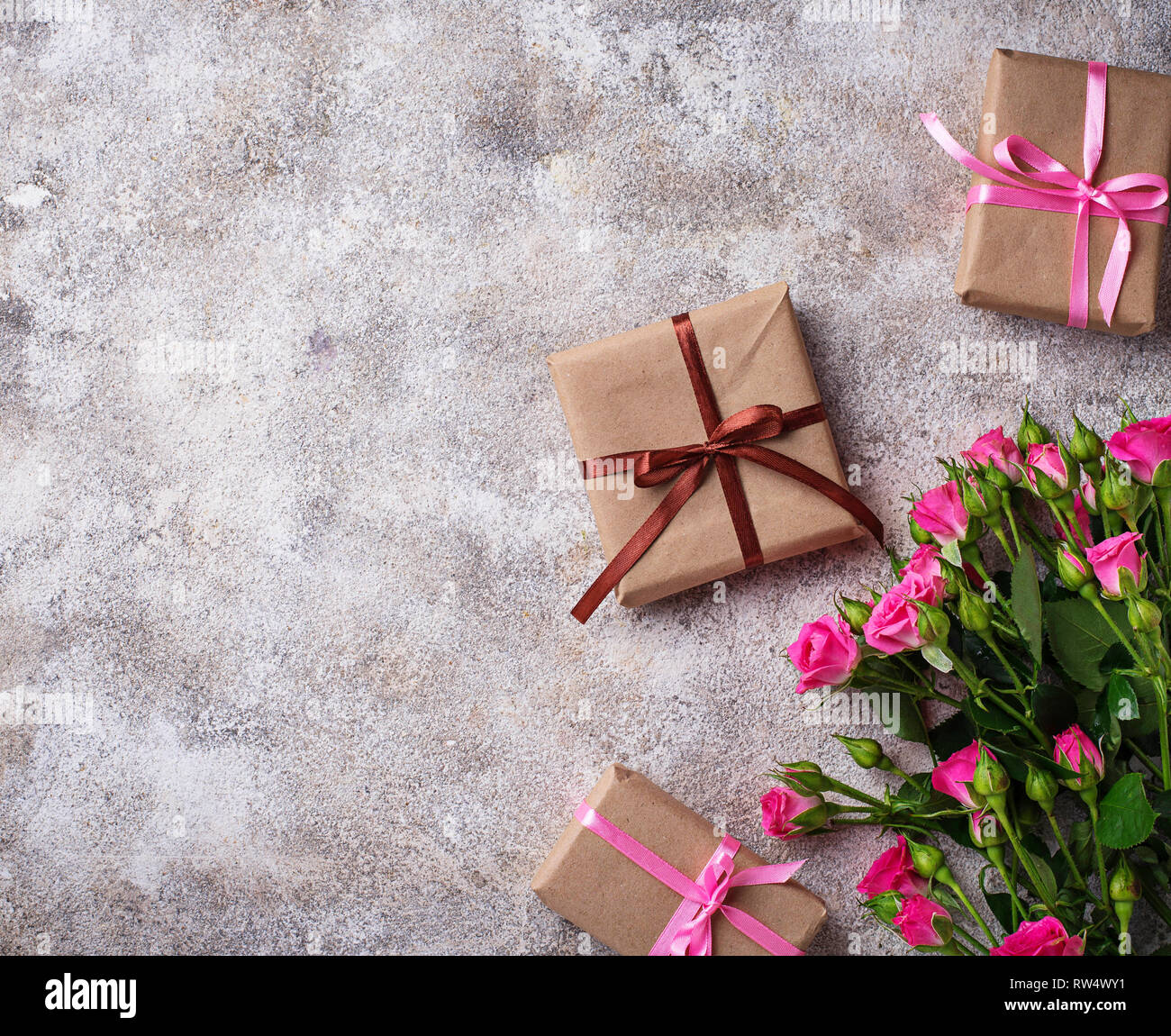 Pink roses and gift boxes with ribbons. Top view Stock Photo - Alamy