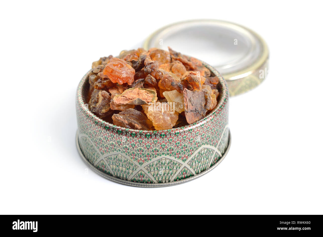 Myrrh is a natural gum or resin extracted from a number of small, thorny tree species of the genus Commiphora Isolated on white, Stock Photo