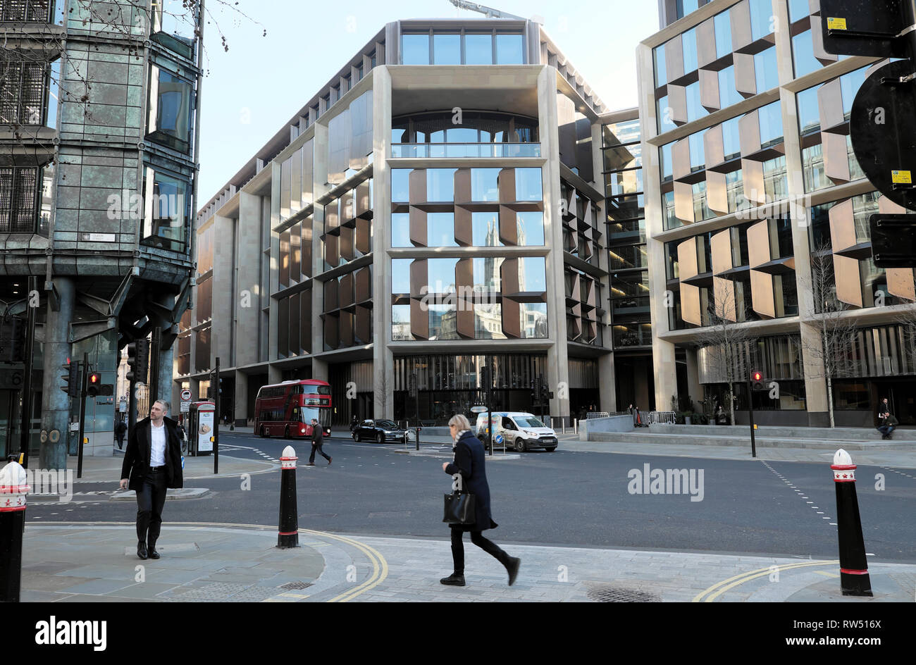 Street view of woman walking near the Bloomberg Building offices on Queen Victoria Street in the City of London England UK    KATHY DEWITT Stock Photo