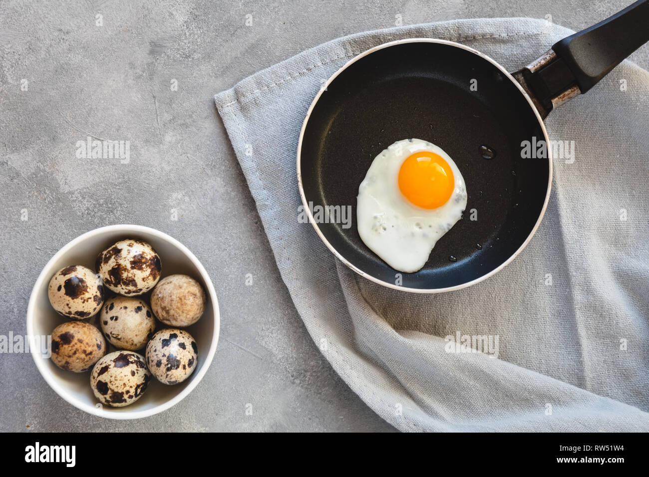 Quail egg fried in a pan. Fresh organic egg. Stock Photo