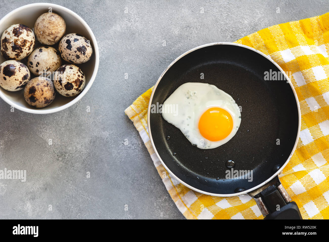 Quail egg fried in a pan. Fresh organic egg. Stock Photo