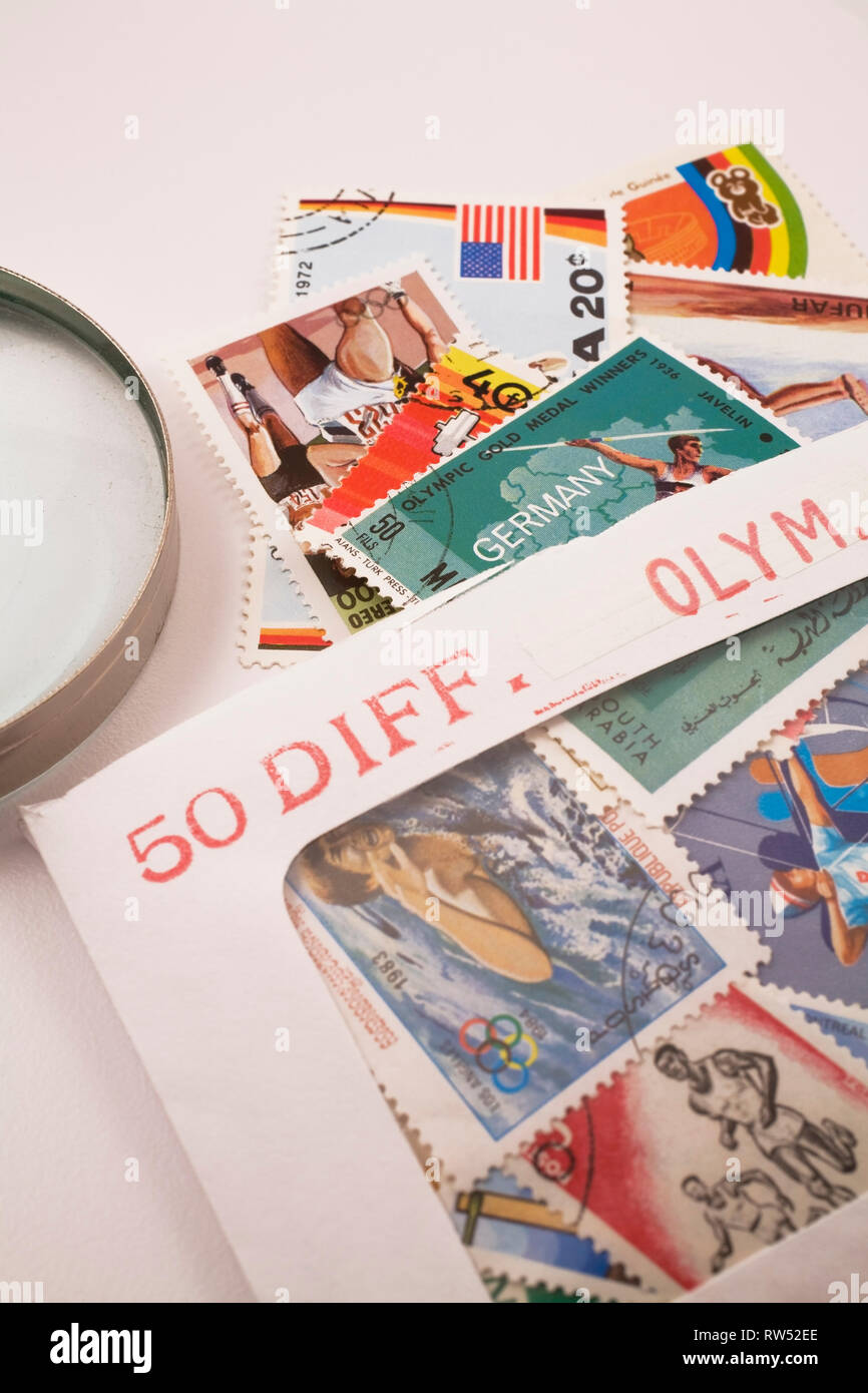 Envelope with assorted old postage stamps from various foreign countries commemorating various summer olympic sports Stock Photo