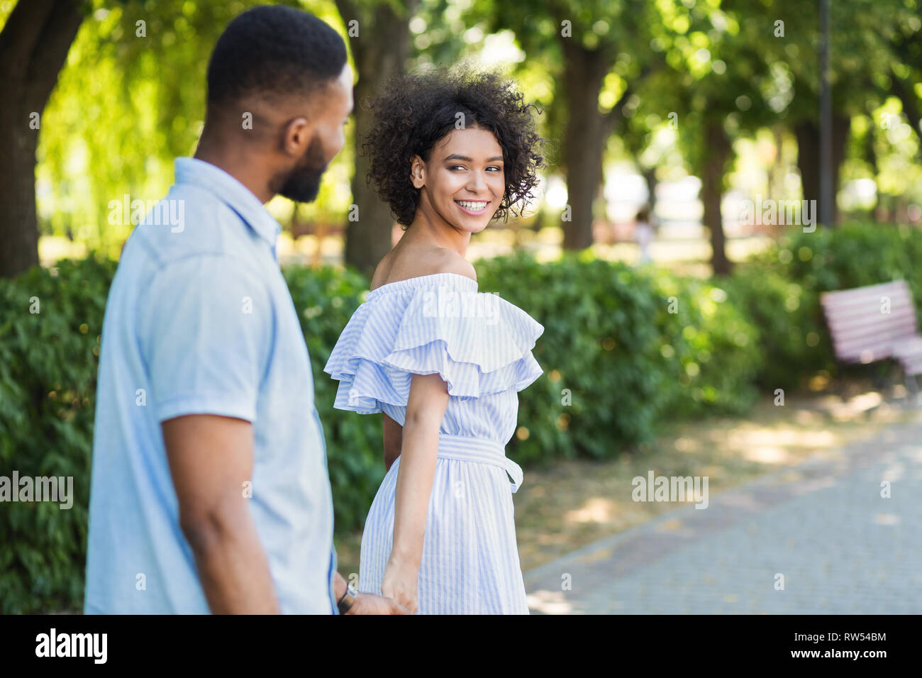 Portrait of loving couple walking in park Stock Photo - Alamy