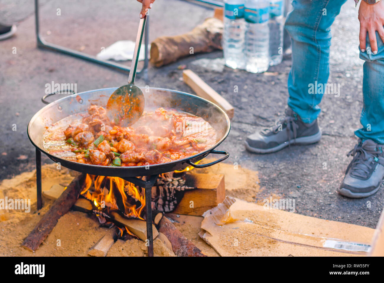 Paella preparation  on the street during fallas festivity. Valencian chicken paella. Stock Photo