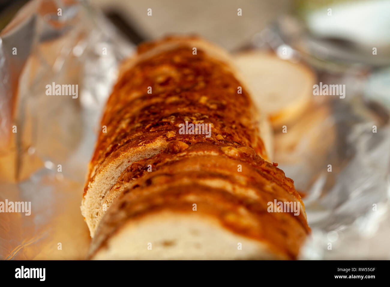Bread roll heated in tinfoil Stock Photo Alamy