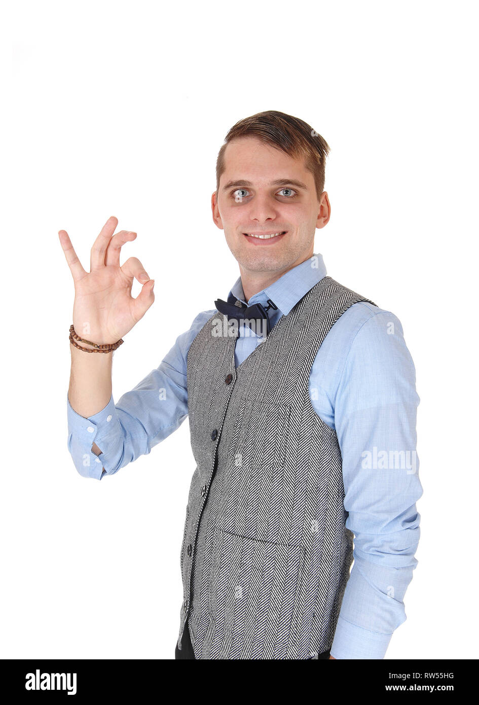 An image of a young happy man smiling and showing with his hand a sign, agreeing with the dissension, isolated for white background Stock Photo