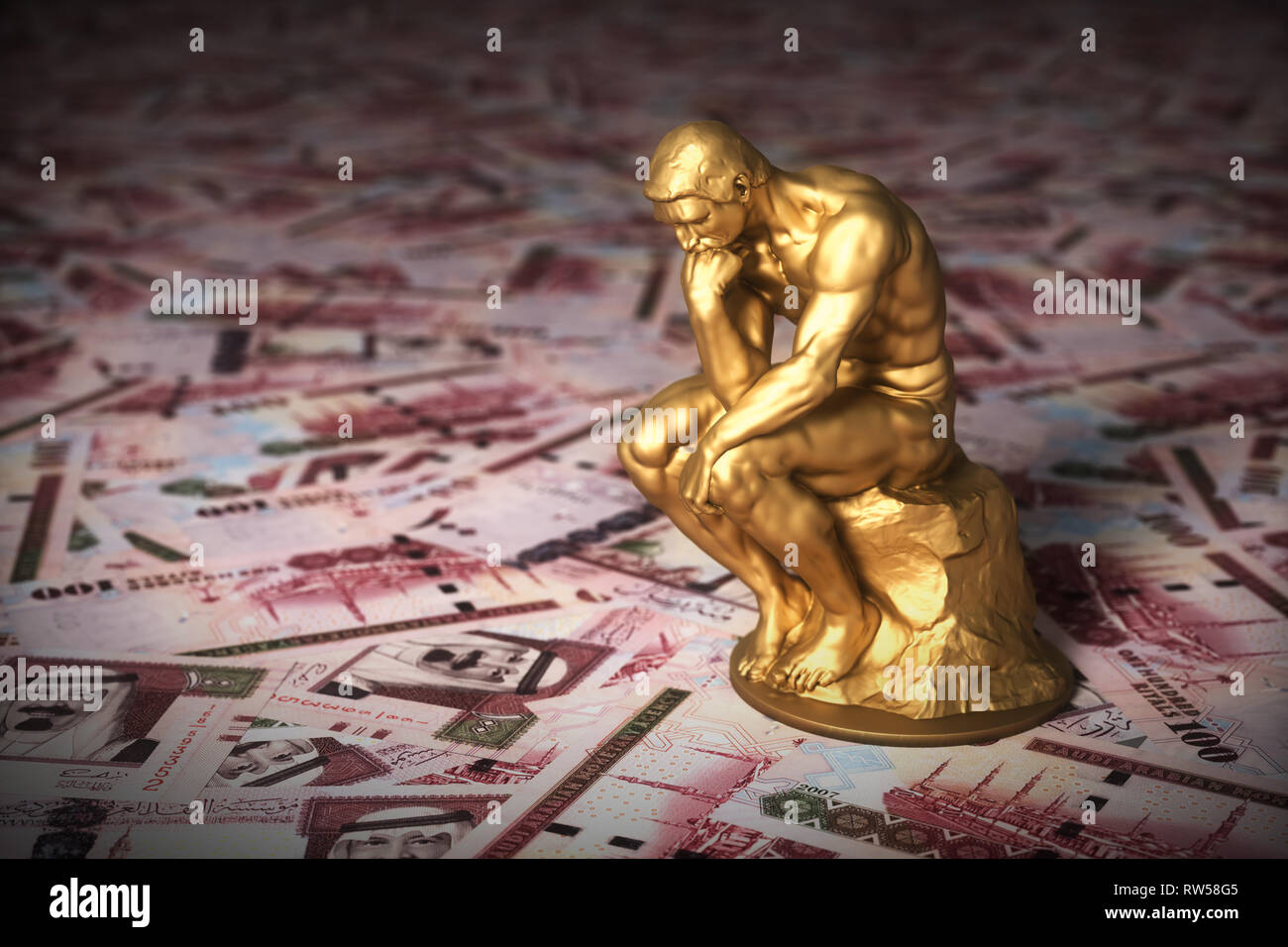 Gold Sculpture Thinker Over Saudi Riyals. 3D Illustration. Stock Photo
