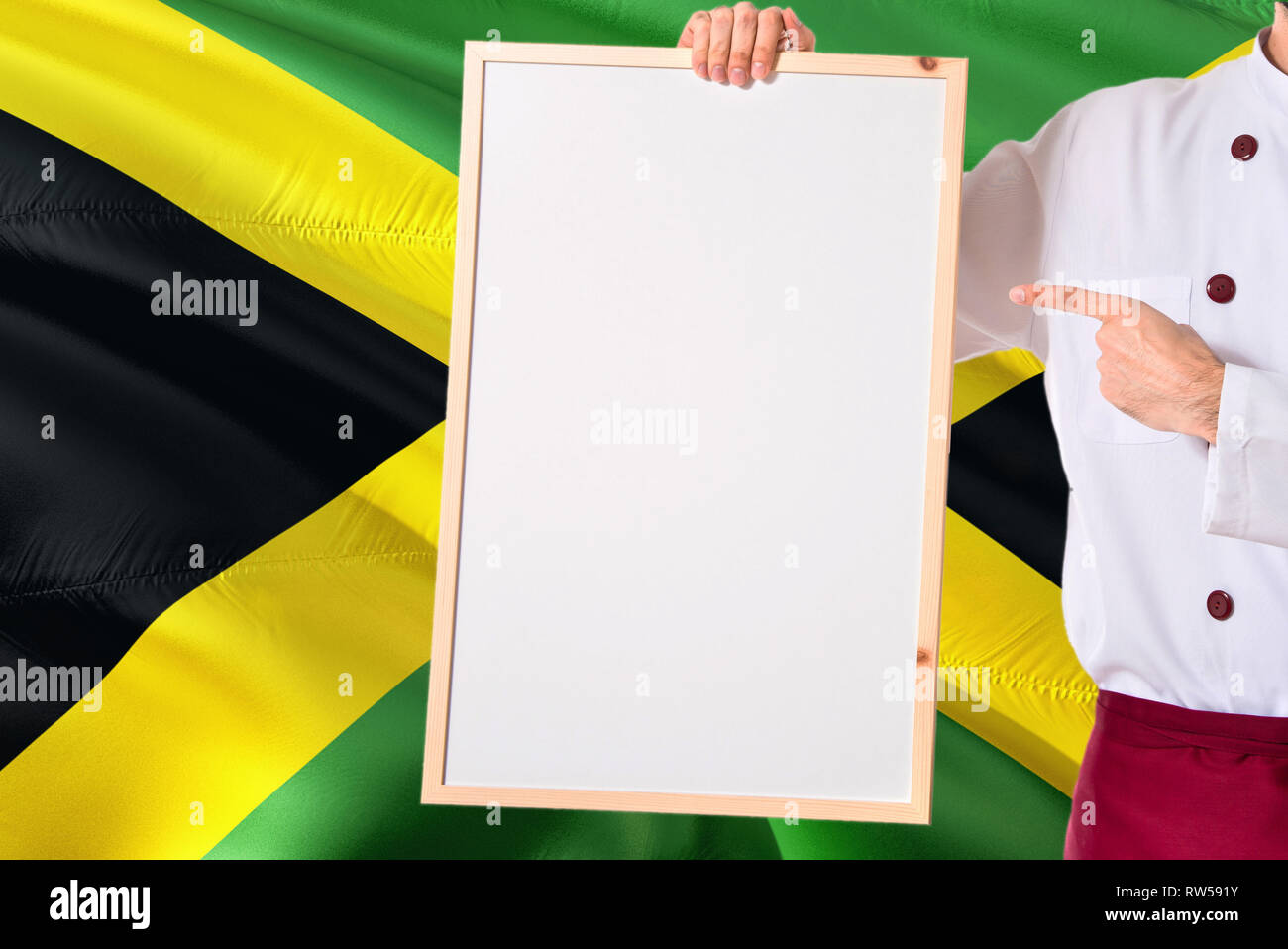 Jamaican Chef holding blank whiteboard menu on Jamaica flag background