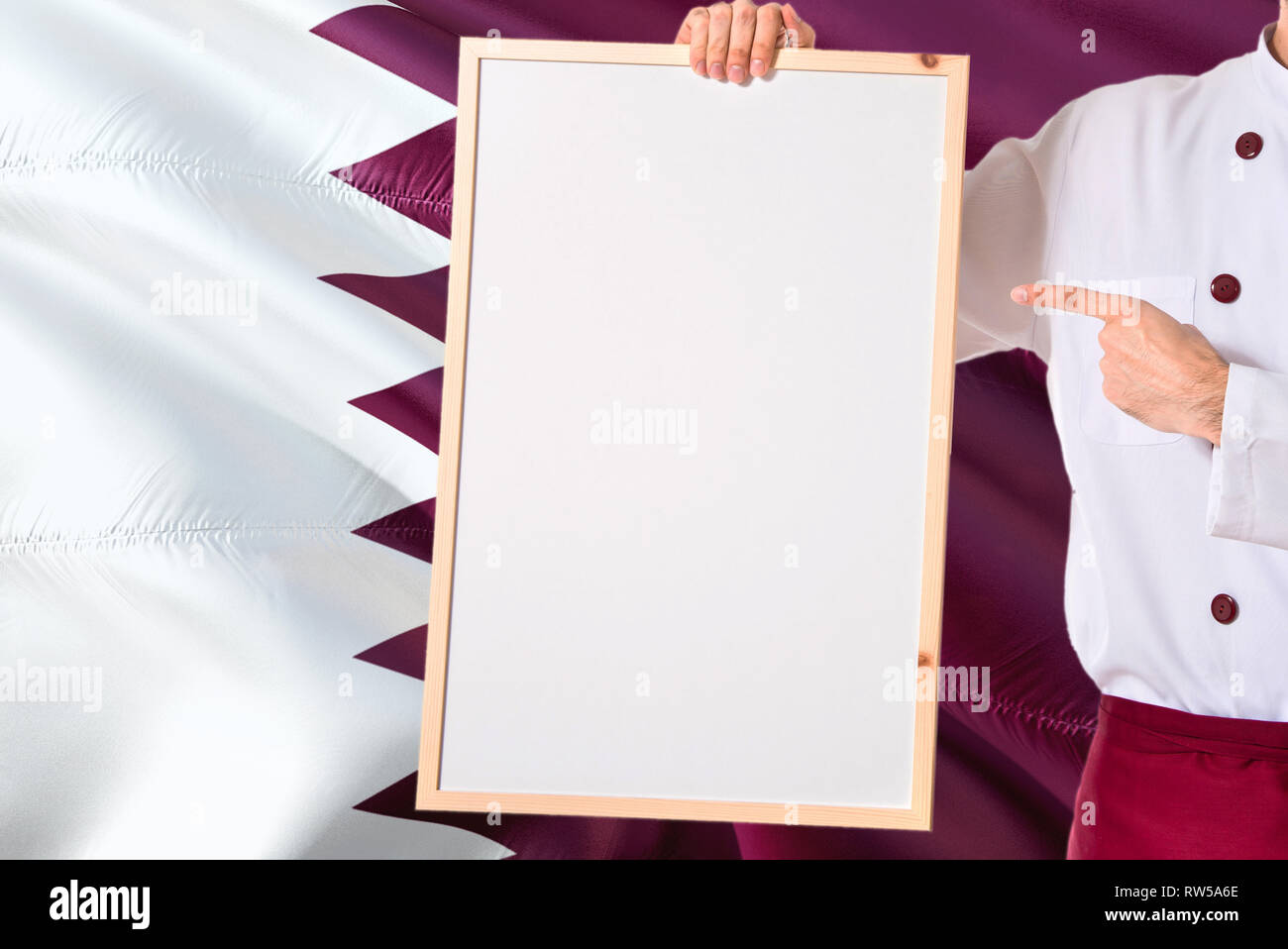 Qatari Chef holding blank whiteboard menu on Qatar flag background