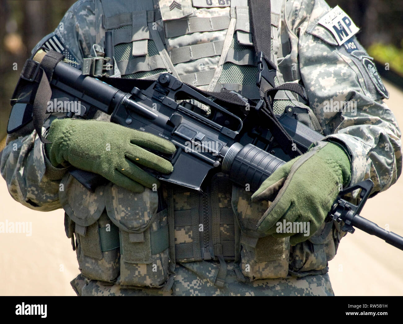 U.S. soldier in camouflage uniform holding his rifle Stock Photo - Alamy