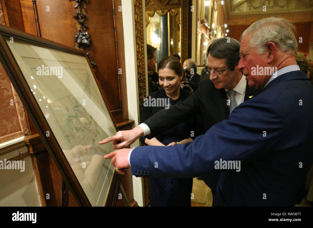 An early survey of the Island of Cyprus created by Lord Kitchener is shown to the Prince of Wales by the President of Cyprus Nicos Anastasiades (centre) during a reception at Buckingham Palace, London, to celebrate the Cypriot diaspora in the UK. Stock Photo